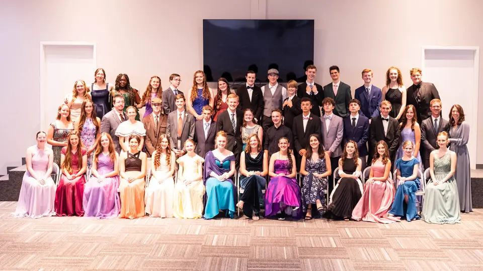 Dozens of guests in gowns and suits gathered for a group photo