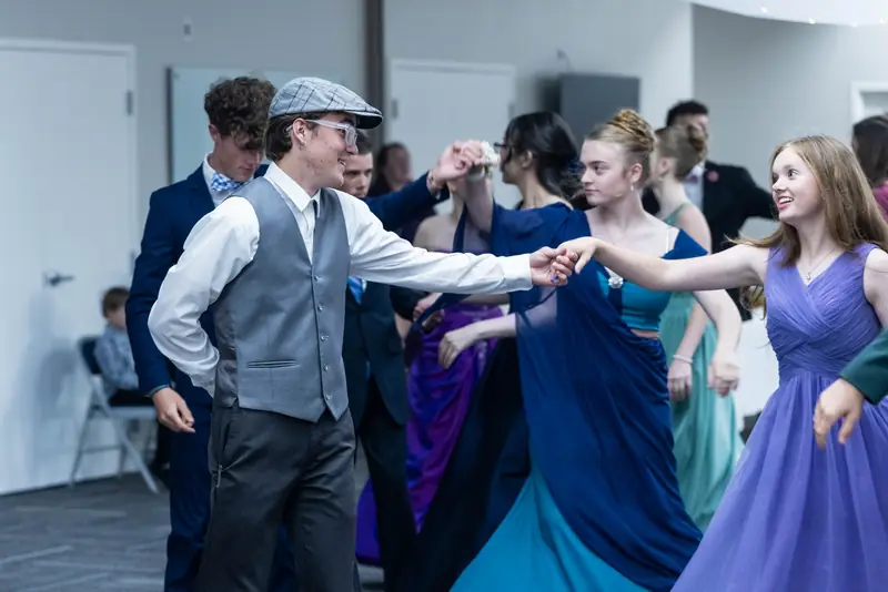 Partners joining hands in a dance line