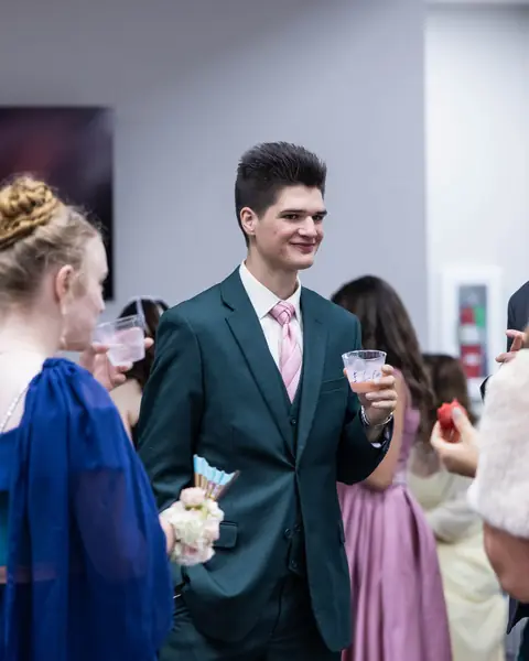 Guests in suits and gowns talking between dances